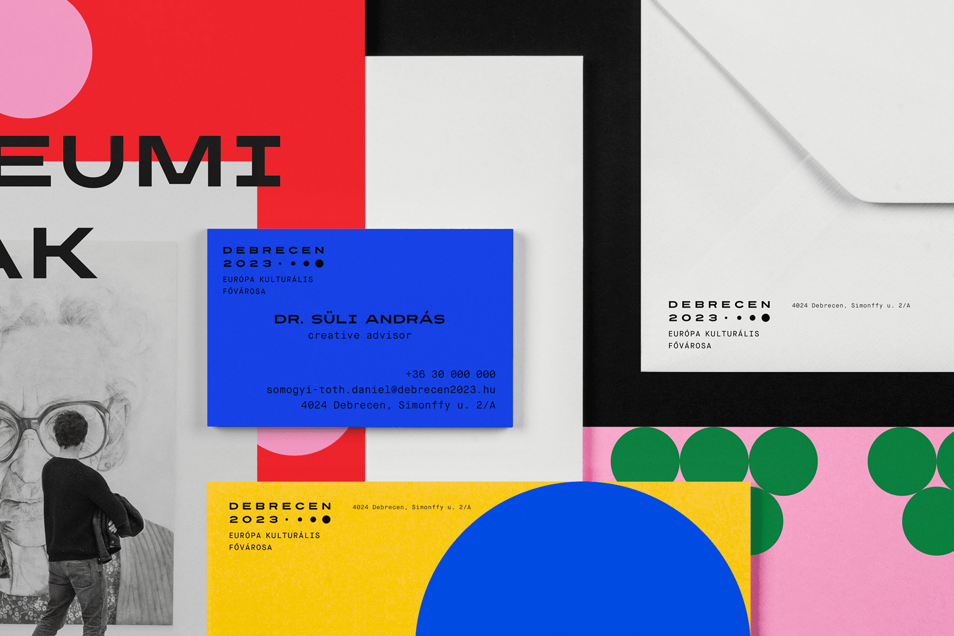 A range of print products in the Debrecen 2023 flexible brand identity, with bold colours and elegant designs.