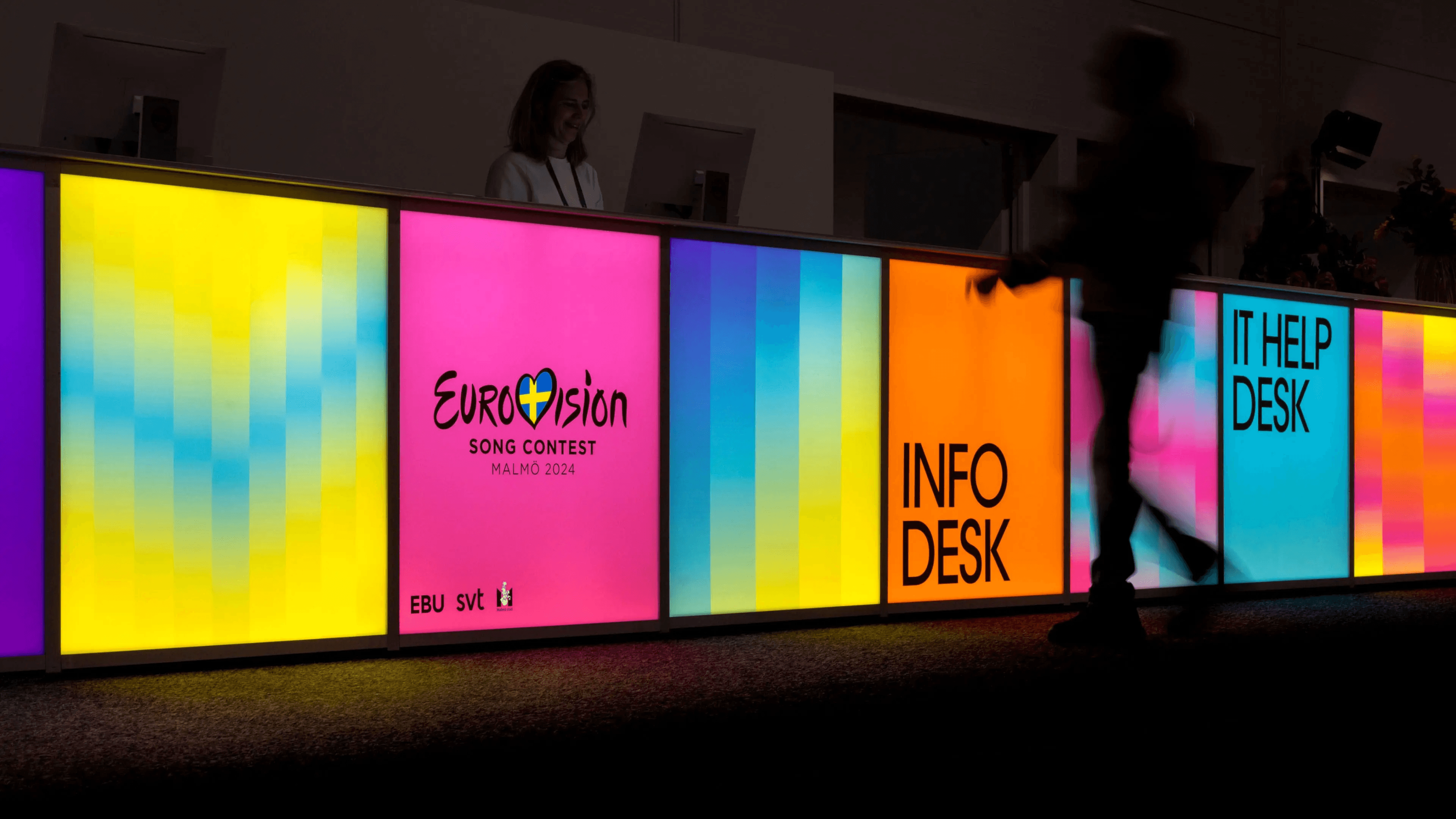 A line of screens showcasing various advertisements for Eurovision 2024.
