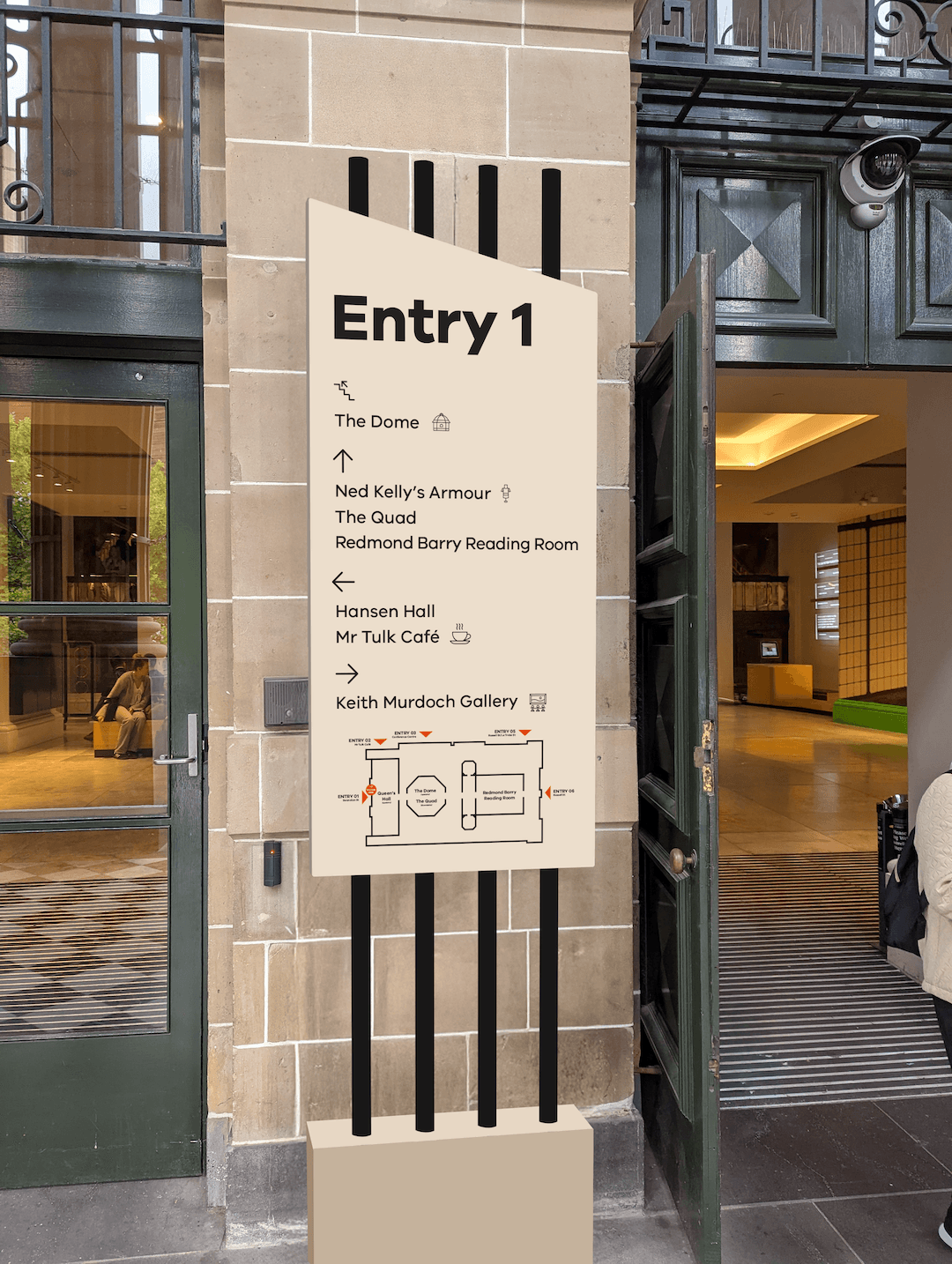 A mockup of a large signage totem outside the front entrance, with directions to major landmarks and a simplified map.