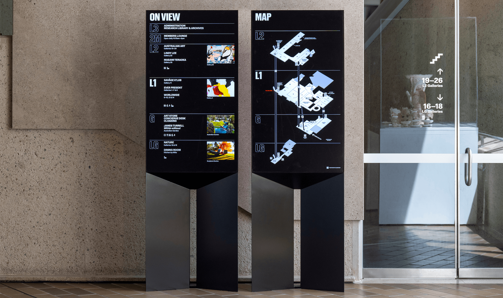 A shot of two totems showing a directory of the NGA and a map respectively.